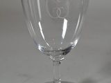 a wine glass that has a monogram on it