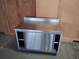 a stainless steel sink in the corner of a kitchen