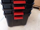 a stack of black boxes with red bins on top