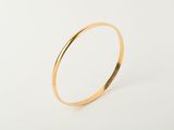 a close up of a gold ring on a white background