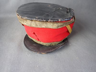 a red hat with a gold band on top of it