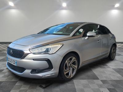 a silver car parked in a room with a checkered floor