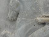 relief of a man on a horse on a stone wall