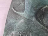 a bronze statue of a man with a hat on his head