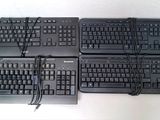four keyboards sitting on top of each other on a table