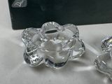 two clear glass candlesticks sitting on a table