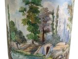 an image of a vase with a painting of a river and trees