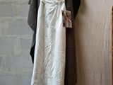 a white dress hanging on a hanger in a room