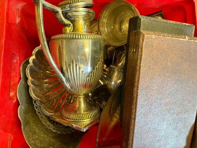 a silver vase sitting in a red box on a table
