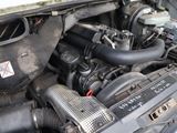 a close up of a car ' s engine with its hood open