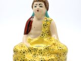 a statue of a woman sitting in a lotus position