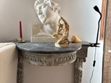 a table with a statue and a lamp on it