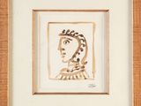 a painting of a woman ' s face is shown in a wooden frame