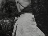 black and white photograph of a woman swinging a tennis racquet
