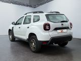 the rear end of a white dacia parked in a garage