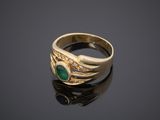 a gold ring with a green stone and diamonds