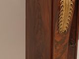 a small wooden cabinet with a mirror on top of it