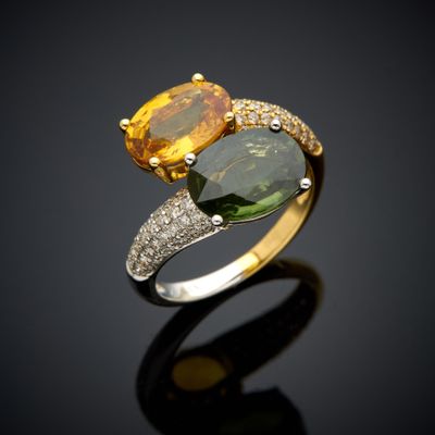 a close up of a yellow and green ring on a black surface