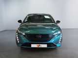 the front view of a green car in a showroom