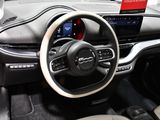 the interior of a car with a steering wheel and dashboard controls