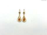 an image of a pair of earrings on a white surface