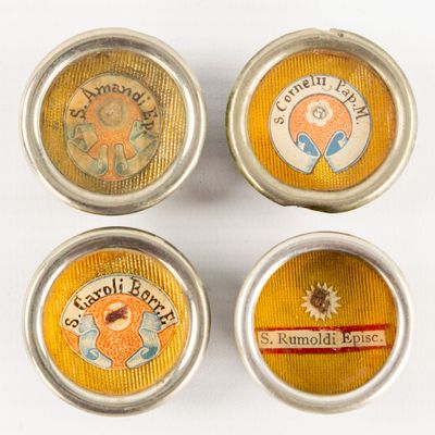 four tins with different labels on them sitting on a table