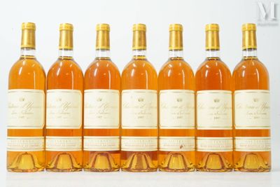 six bottles of wine are lined up in a row on a table