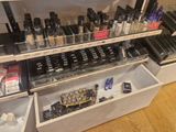 a display of makeup products on a shelf in a store