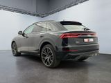 the rear end of a grey audi qx parked in a garage