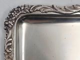 a silver tray with a flower design on it