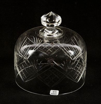 a clear glass dome with a lid on a black background