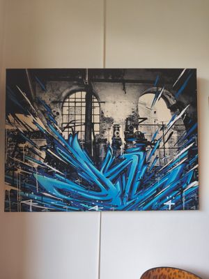 a painting on the wall above a chair in a room