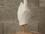a white glove on a wooden stand on a table