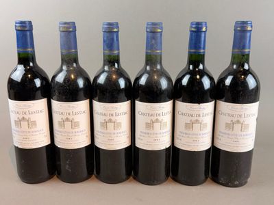 six bottles of wine are lined up in a row on a table