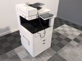 a white printer sitting on top of a stack of drawers