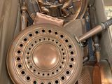 a box with a bunch of copper pots and pans in it