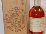 an old bottle of wine sitting next to a wooden box
