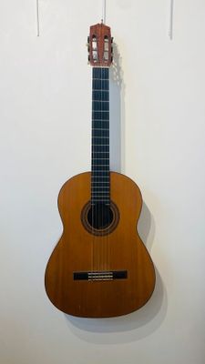 a guitar hanging on a wall in a room