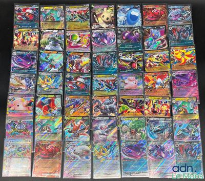 a bunch of pokemon cards sitting on top of a table