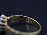 a close up of a ring with a diamond in it