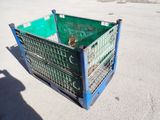 a green crate sitting in the middle of a parking lot
