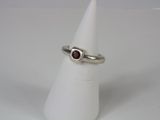 silver ring with a garnetite stone in the middle of it