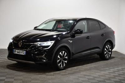 une voiture noire garée dans une pièce au sol en damier