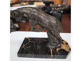 a bronze statue of a dog on a marble base