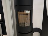 the large black stove is in the corner of the room
