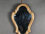 a mirror hanging on a wall in a room