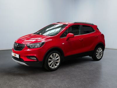 a red buick suv is parked in a large room