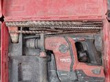 a red box with a drill and a hammer inside of it