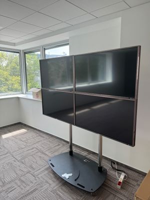 a large flat screen tv sitting on a stand in a room
