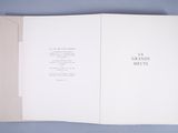 an open book on a blue surface with a picture of a cat